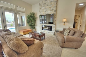 Living room has french doors that open to the patio & pool