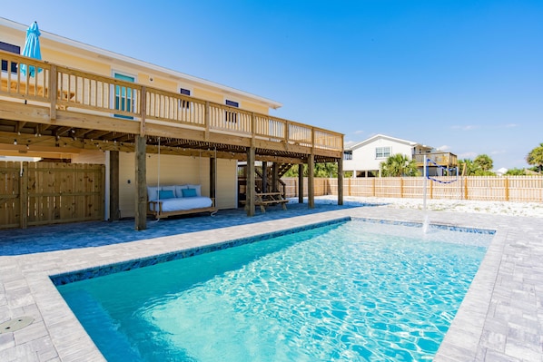 Private pool with sun ledge and bed swing under the back porch. 