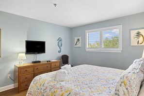 Primary Bedroom with King Bed with dresser and TV