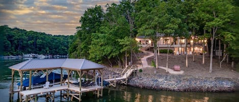 View from the water of the dock and lake house at sunset