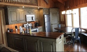 Fully remodeled kitchen with custom cabinets and a custom dining table for 8. 