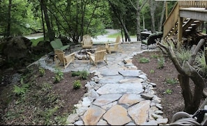 Stone fire pit area with creek. 