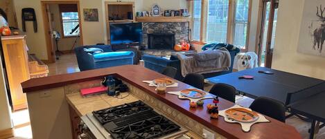 Kitchen bar/island. Seats four. Interchangeable dinner/ping pong table.  