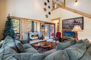 Comfortable couch with TV and a stove.