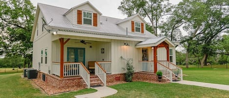 New railing and cozy front porch for coffee or wine sipping.