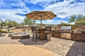 Huge outdoor kitchen with built in BBQ, searing grills and gas fire pit.