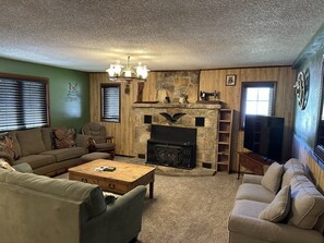 Large living room, plenty of seating, large flat screen