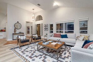 Large livingroom with an abundance of natural light and plenty of seating