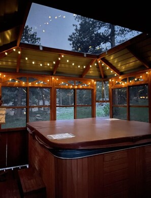 Relax in the hot tub under the twinkle lights
