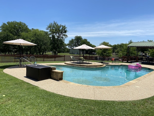 Large swimming pool with diving board and lights 