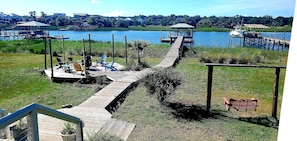 View of fire-pit, dock and pier head from the porch