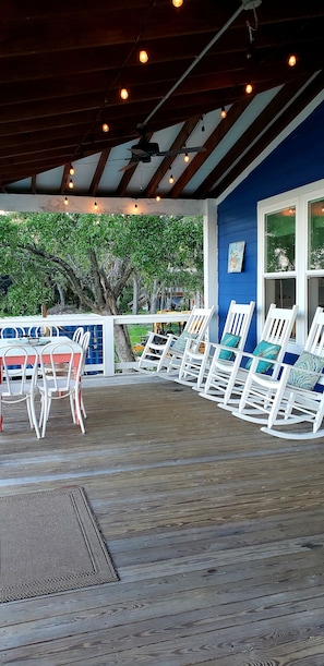 Rocking chairs & dining table for 6 on a spacious porch