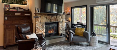 Spacious living room w wood burning fireplace.