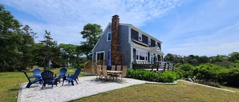 Outdoor spaces include a deck and shell patio with table and fire pit