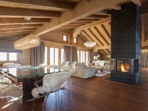 living room and dinning table with a warm and modern fire place 
