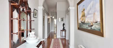 The charming entryway welcomes you with an arched doorway and intricate crown moulding, setting the tone for your stay at Hampden Manor.