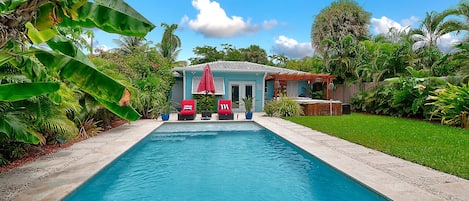 Backyard Oasis showing the large green space, pool, & patio decking area