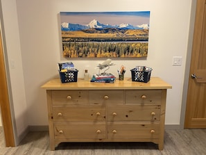 Entryway dresser with brochures, games, and beach/hot springs towels
