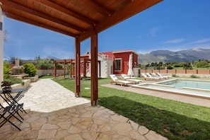 Outdoor shower, sun beds and umbrellas by pool area