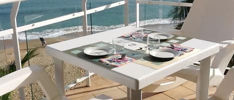 Table is set at the balcony, with waves literally braking at your feet