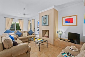 Ground Floor Living Area with Comfortable Seating, Patio Doors Leading to Pool