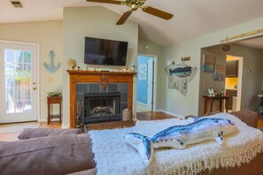 The living room connects the home's kitchen, dining room and master bedroom areas.