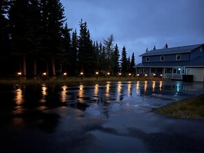 Outside lighting and the reflection on the wet asphalted driveway.