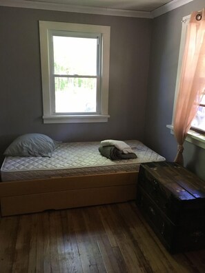 Trundle bed in front room, separated by a curtain for privacy if needed