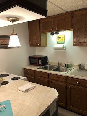 Kitchen With New Microwave and Refrigerator