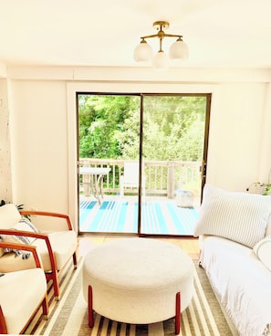 Living room area with access to outdoor deck.