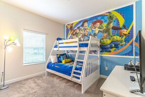 Bedroom 4 kid-themed with a double and twin bunk bed and a TV.