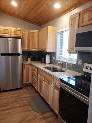 Kitchen - full size refrigerator, stove/oven and microwave.  Double sink.  