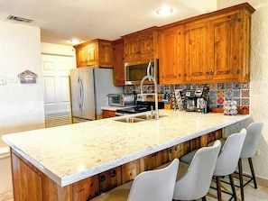 Stainless steel dishwasher, stove, microwave, refrigerator and quality Moen faucet, garbage disposal, and gorgeous quartz countertops!