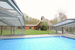 Heated pool with ceiling and sides retracted