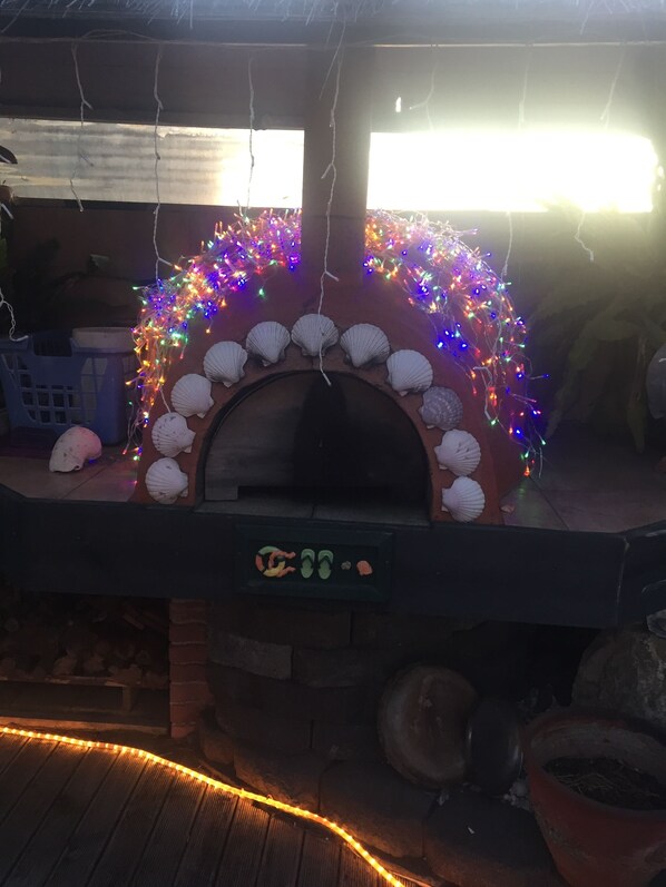 Pizza oven with Xmas lights at front house
