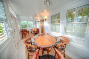 Step into the enclosed sunroom with seating