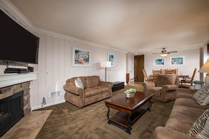 A beautiful stone fireplace enhances the living area.