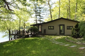 front of house. lake in background