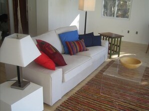 living room- couch faces 25 feet of glass view of lake