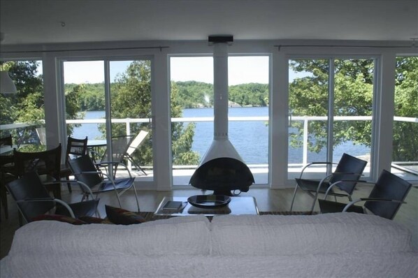 living room of upstairs unit- modern Malm gas fireplace and 25 feet of glass 