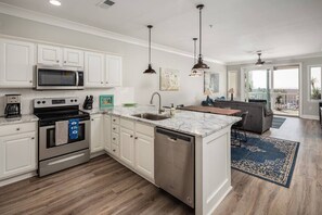 Open kitchen with granite countertops, enjoy the ocean view while cooking your dinner! 