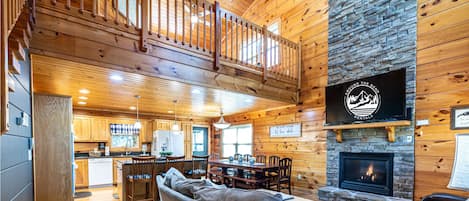 Tall vaulted ceilings await you, as you enter the open concept kitchen, living area with a gas fireplace. 