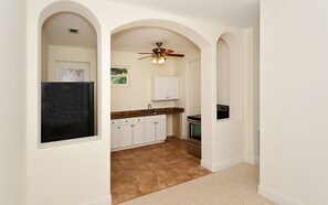 Arched room divider showing 10' high ceilings + 3/4 wall between LV. rm & Bedrm.