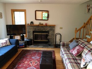 Living room area with fireplace, large couches, HD TV, Cable, DVD, Apple TV