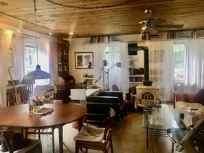 the dining and living area is focussed on a wood stove.  books line the walls.