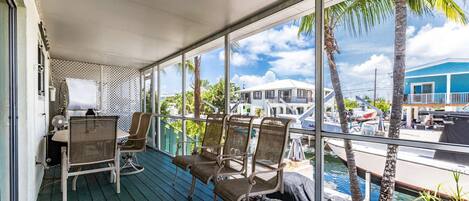 Relax on the shaded, screened porch while enjoying a delightful canal view.