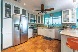 The updated kitchen showcases modern convenience with stainless steel appliances and elegant granite countertops.