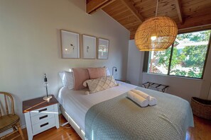 Queen Bedroom with garden views one side and water views the other