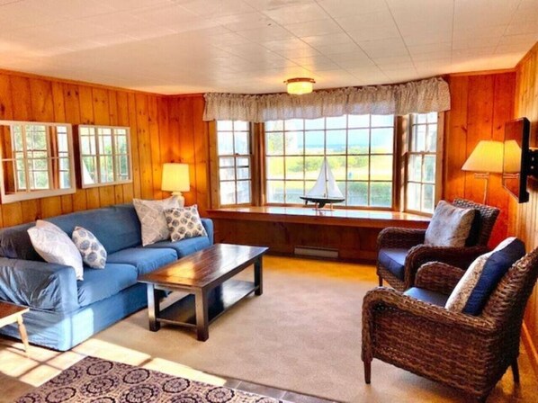 Dune Suite living room with large bay window with ocean view.