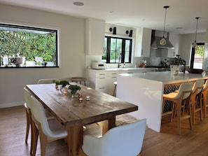 Kitchen with window and door to outside dining